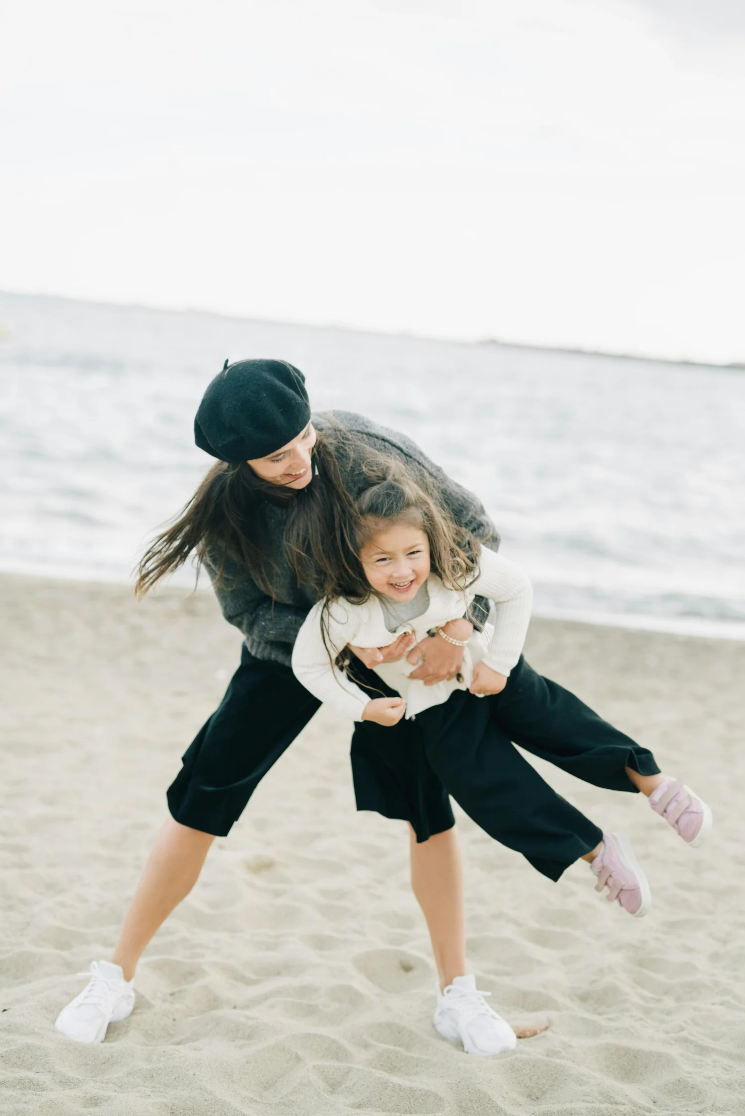 Mother playing with her child at the beach